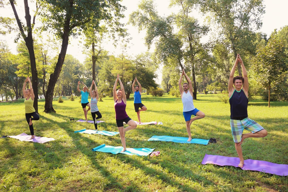 A Group of People Doing Yoga Outdoors