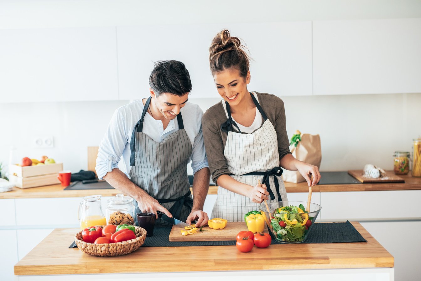 Young couple cooking healthy