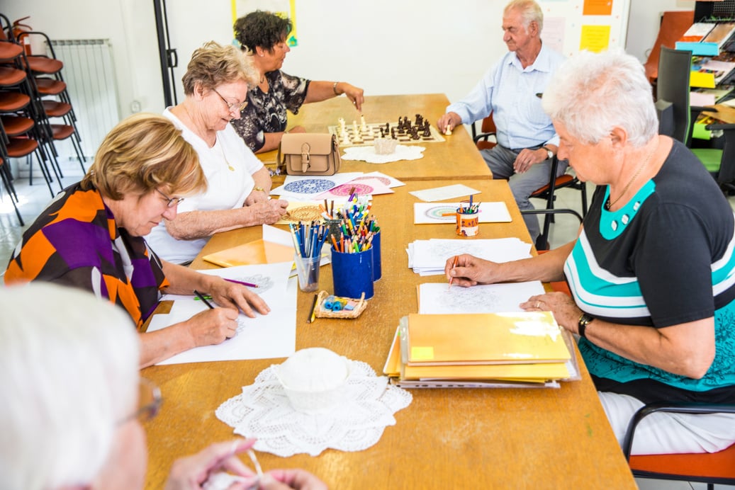 Group Of Active Seniors Socializing At The Activity Center